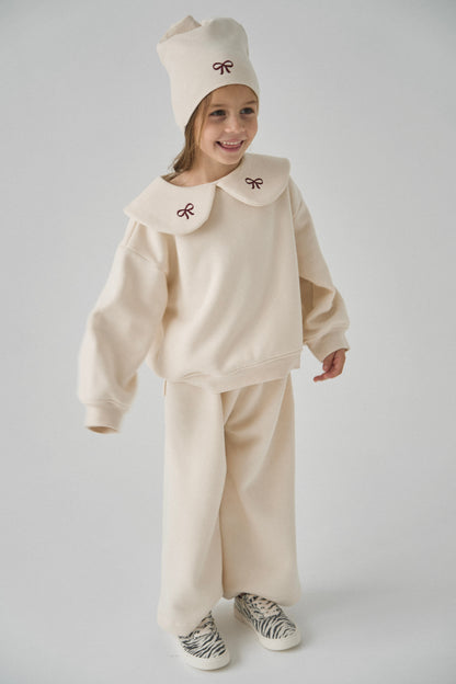 Dres kremowy z kokardkami